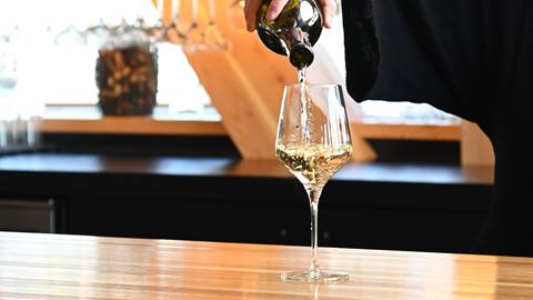 white wine being poured in wine glass