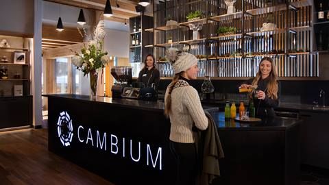 Cambium Spa front desk with employees and guest