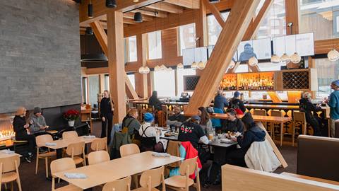 interior of crows bench with people at table and bar