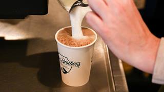 Steamed milk being poured into a latte at Mojo Coyote Cafe