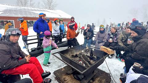 Skiers taking a break by the Outback bonfire