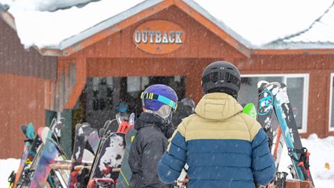 Skiers walking up the The Outback