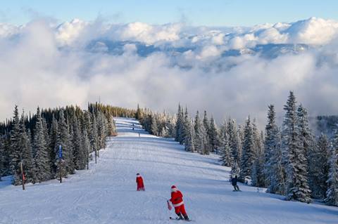 Santa and Mrs Claus skiing off in the distance