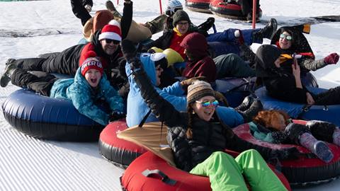 group of people on the tubing hill