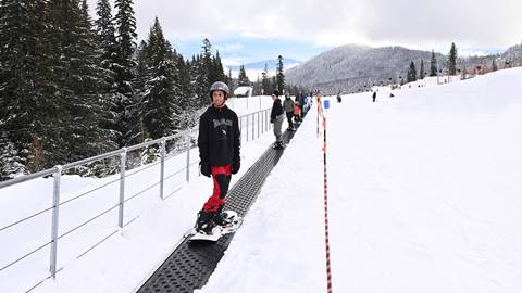 Beginner snowboarder riding Musical Carpet at Schweitzer.