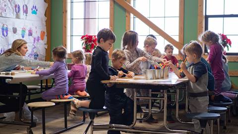 Kids at a table doing arts and crafts at Schweitzer's Children's Center. 