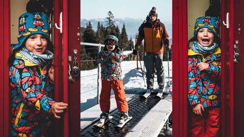 Young skier standing in a locker, also standing on the Musical Carpet with his dad at Schweitzer. 