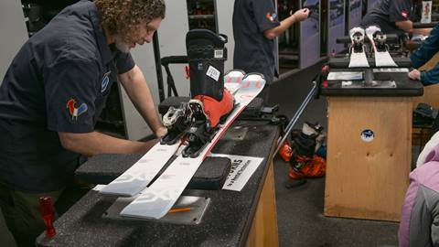 Schweitzer rental technician, sizing ski bindings for a guest.  