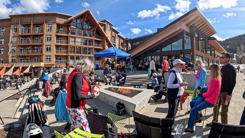 A group of people enjoying spring day on the Crow's Bench Patio