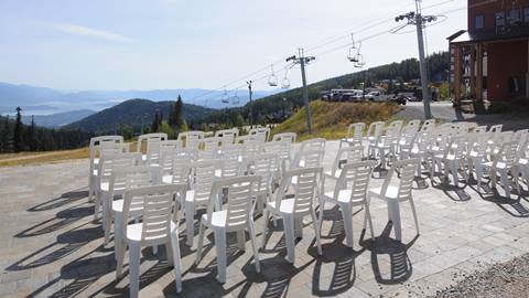 Chairs set up on the Creekside Patio at Schweitzer with a view of Lake Pend Oreille 