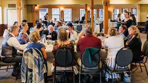 People sitting at a table for a wedding dinner. 