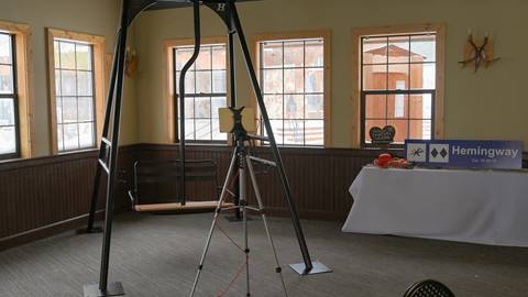 Photo booth set up with a chairlift, props and ski sign in the Lakeview Mezzanine at Schweitzer