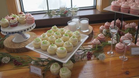 Plates of cupcakes on a table with a view for a wedding reception at Schweitzer. 