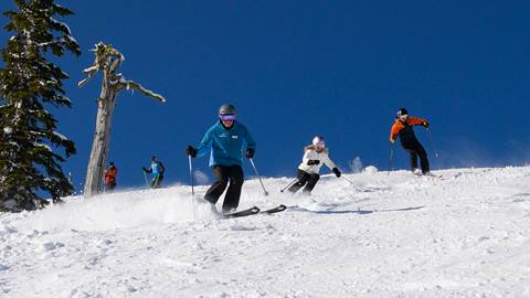 Ski instructor and students skiing linked turns at Schweitzer 