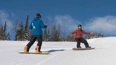 Adult snowboarding during a lesson at Schweitzer 