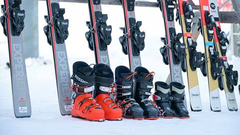 skis and boots on ski rack