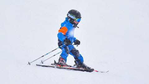 Child skiing in a snowstorm