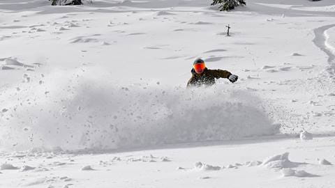 Snowboarder on a sunny powder day at Schweitzer