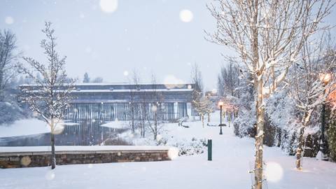 View of Sand Creek and the Cedar Street Bridge with snow falling