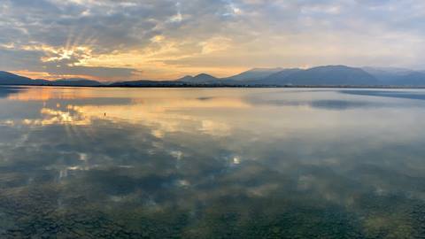 View of the sunset over Lake Pend Oreille from the shore