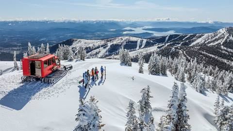 Aerial view of skiers, snow cat, and Schweitzer terrain