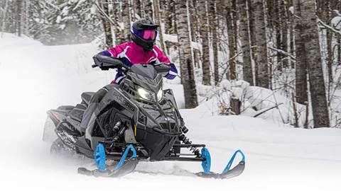 person riding a polaris snowmobile