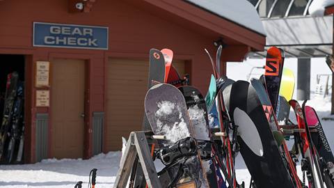 Exterior image of the gear check door with skis and boards in the rack