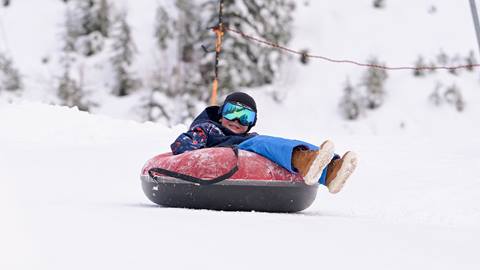 Young child on the tubing hill