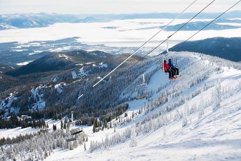 Guest on the chairlift with the lake in the background