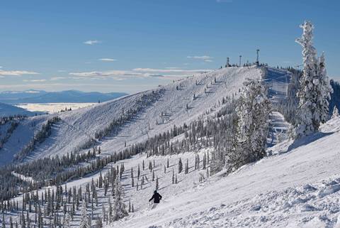 View of mountain bowl with skier