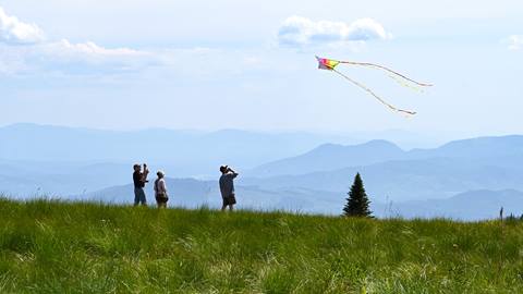 Family flying a kite at the summit of Schweitzer