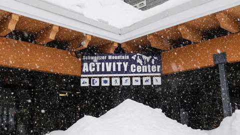 snow covered image of the activity center sign