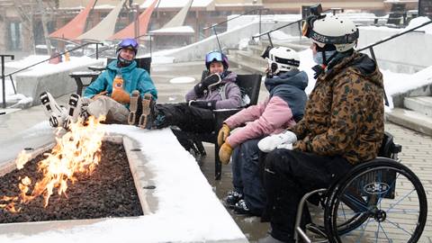 Group of friends hanging out by the outdoor firepit