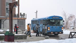 Guests getting on a shuttle bus in the winter.