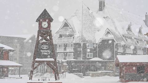 snowy photo of the Schweitzer village and clocktower