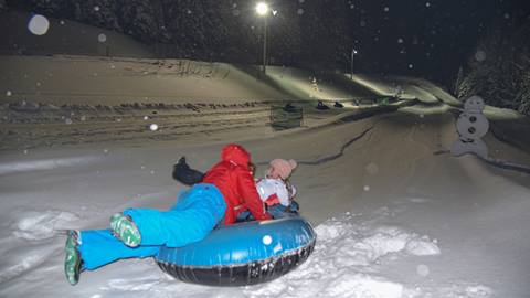 snow twilight tubing night family