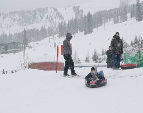 Kid snow tubing at Hermit's Hollow Schweitzer Mountain