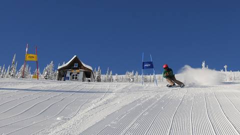 nastar adult skier blue sky sunny corduroy