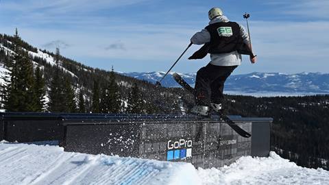 Skier sliding a flat rail in the terrain park at Schweitzer